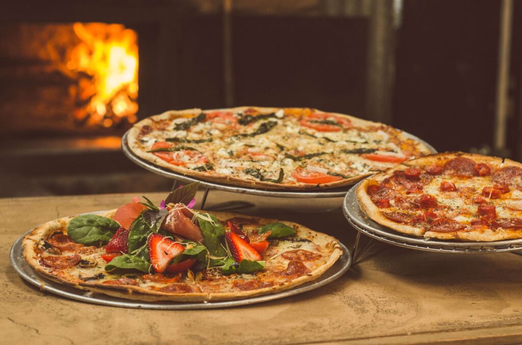 image of three different sized pizzas