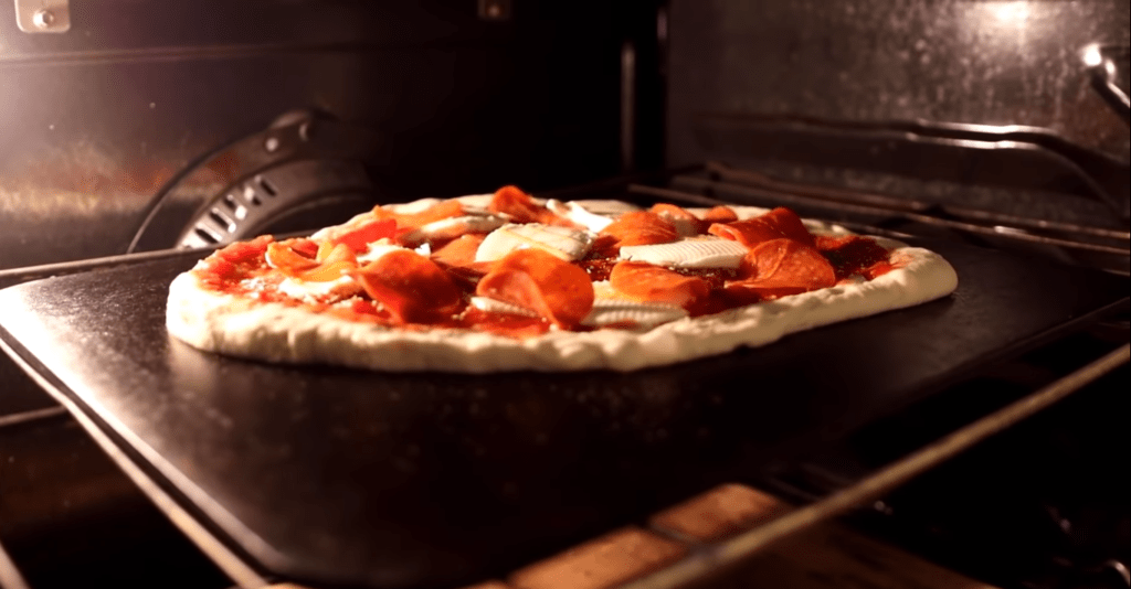 pizza on a baking steel ready to be cooked