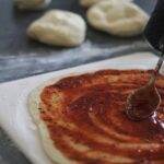 making pizza on the rectangular baking stone