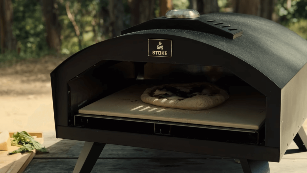 appearance of stoke gas powered pizza oven with pizza being cooked